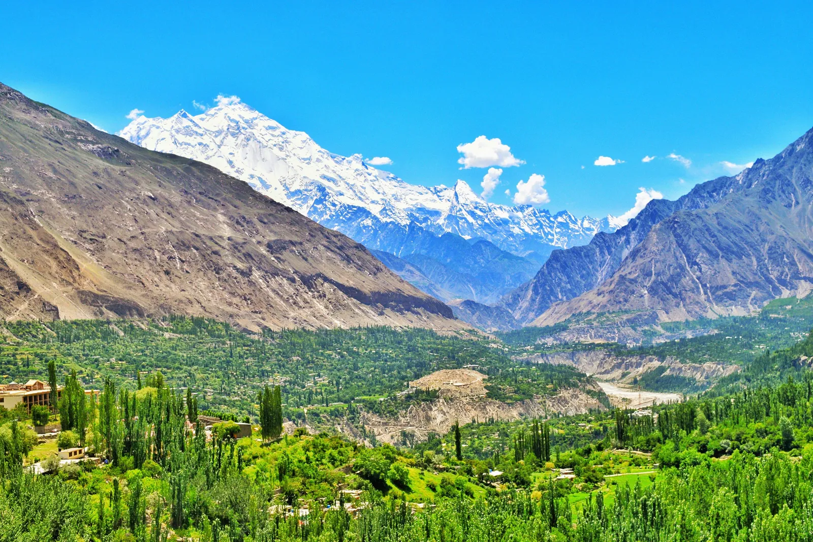 Green terraces of Hunza Valley below snow-capped peaks