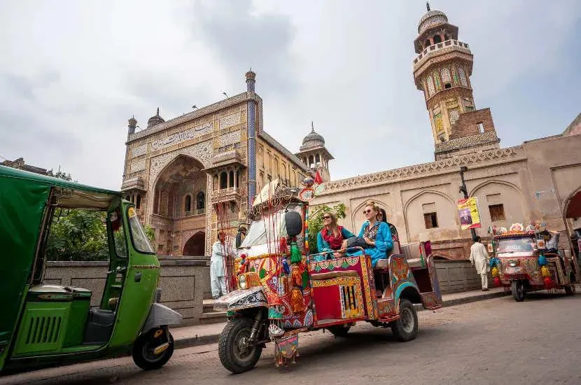 A colourful painted rickshaw outside Wazir Khan Mosque